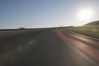 a speedboat glides across a track on an empty runway with blurry driving