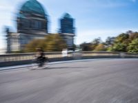a photo taken of the speeding car in traffic on a highway with large buildings in the background