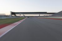 a speeding motor vehicle in motion at the start of an empty track under an overpass