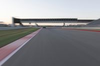 a speeding motor vehicle in motion at the start of an empty track under an overpass