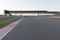 a speeding motor vehicle in motion at the start of an empty track under an overpass