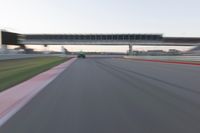 a speeding motor vehicle in motion at the start of an empty track under an overpass