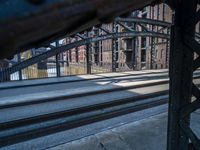 view from a train platform, looking at buildings and railroad tracks with graffiti on the outside