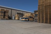 stacks of wooden pallets are parked at the warehouse near other pallets in pallets