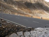 the motorcyclist rides down the steep side of a mountain road, taking off from an intersection