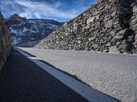 the side of the road is covered with large stones in order to make it stand out