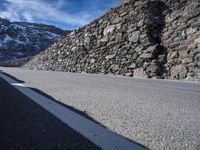 the side of the road is covered with large stones in order to make it stand out