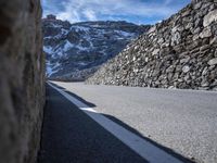 the side of the road is covered with large stones in order to make it stand out