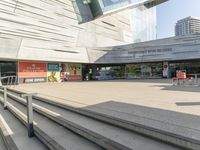 steps going up to a museum where two people are standing on each side of them