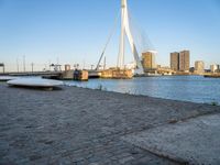 there is a stone bench that has been placed by the water in front of it