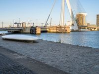 there is a stone bench that has been placed by the water in front of it