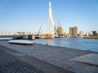 there is a stone bench that has been placed by the water in front of it