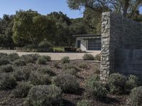 this is a stone building with an exterior and vegetation around it as well as the door