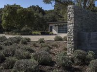 this is a stone building with an exterior and vegetation around it as well as the door