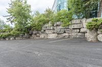 a parking lot that has a stone wall around it to provide a parking spot for the cars