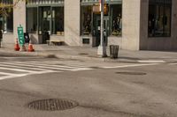 a stop sign is on the road at a corner near a building with some windows