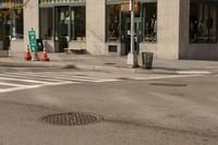 a stop sign is on the road at a corner near a building with some windows