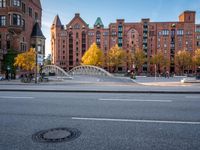 there is a stop sign at the corner of a street in a city area with red brick buildings