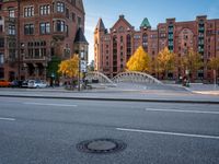 there is a stop sign at the corner of a street in a city area with red brick buildings