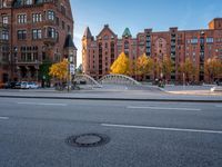 there is a stop sign at the corner of a street in a city area with red brick buildings