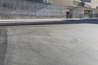 a stop sign on the street in a city area under a fenced in parking lot