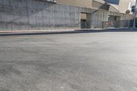 a stop sign on the street in a city area under a fenced in parking lot