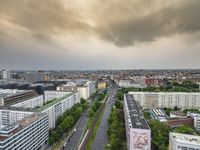 an aerial view of traffic along the busy streets of the city during a stormy day