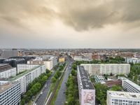 an aerial view of traffic along the busy streets of the city during a stormy day