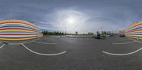 an image of a colorful object in the air in a parking lot area with cars