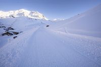 Straight Down the Road: Alps Under Clear Sky