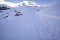 Straight Down the Road: Alps Under Clear Sky