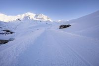 Straight Down the Road: Alps Under Clear Sky