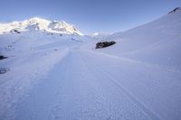 Straight Down the Road: Alps Under Clear Sky