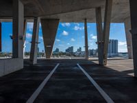 this looks like an under - bridge at a city in the us, with tall buildings and skyscrapers