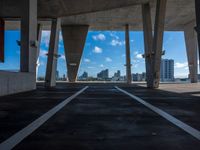 this looks like an under - bridge at a city in the us, with tall buildings and skyscrapers