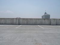 a parking lot and wall are pictured in a photo from the perspective point of view