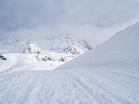 Straight Down the Road: A View of the Alps' Majestic Mountains