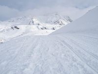 Straight Down the Road: A View of the Alps' Majestic Mountains