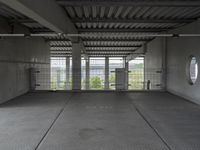 empty industrial space with grey metal flooring and open areas in front of the camera