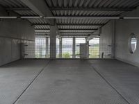 empty industrial space with grey metal flooring and open areas in front of the camera