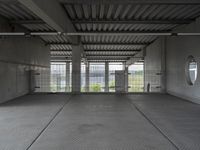 empty industrial space with grey metal flooring and open areas in front of the camera