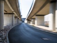 a blurry photo of two highway tracks and the center of a street with cars and traffic