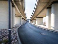 a blurry photo of two highway tracks and the center of a street with cars and traffic