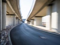 a blurry photo of two highway tracks and the center of a street with cars and traffic