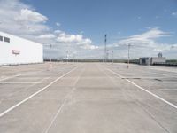 a large parking lot that has been freshly cleaned for sale in the summertime with sky and cloud background