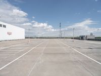 a large parking lot that has been freshly cleaned for sale in the summertime with sky and cloud background