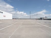 a large parking lot that has been freshly cleaned for sale in the summertime with sky and cloud background