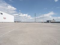 a large parking lot that has been freshly cleaned for sale in the summertime with sky and cloud background