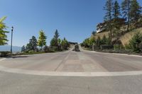 view down the street, looking back to a residential complex with trees on both side