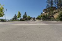 view down the street, looking back to a residential complex with trees on both side